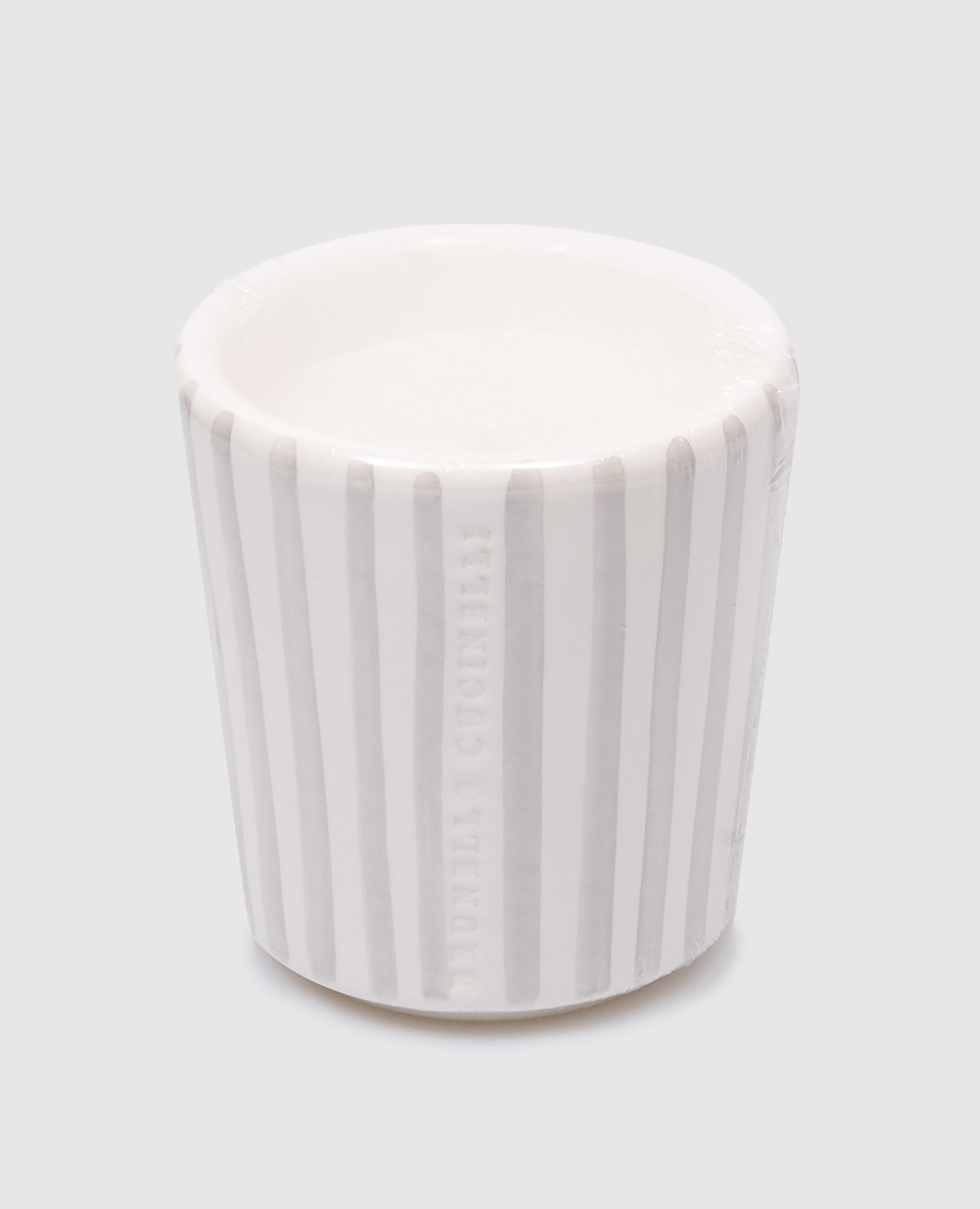 A white scented candle in a gray striped ceramic candle holder with a logo