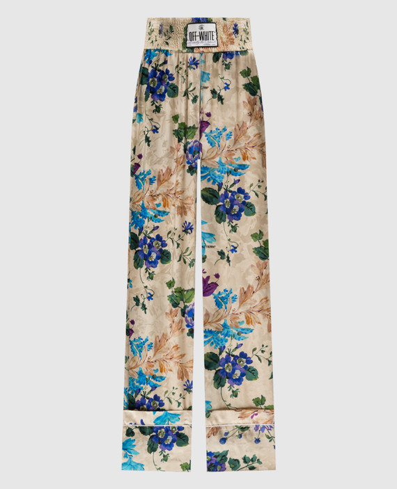Beige trousers in a floral print with a logo