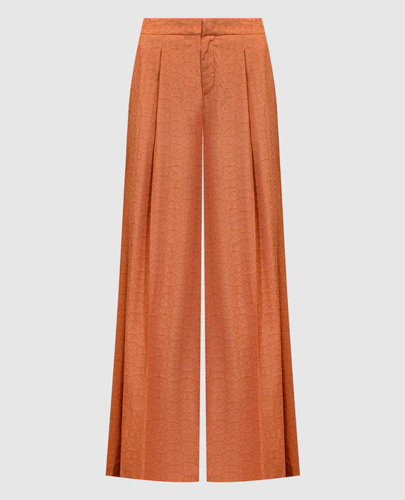 Orange palazzo pants in a branded pattern